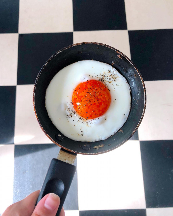Photo of a skillet with a fried Heritage Happy egg, topped with pepper
