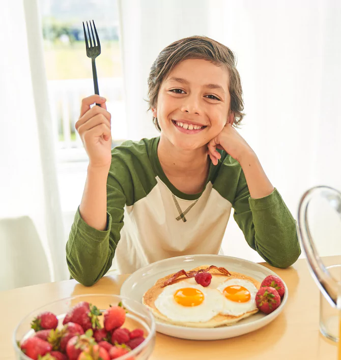 happy egg kid at breakfast